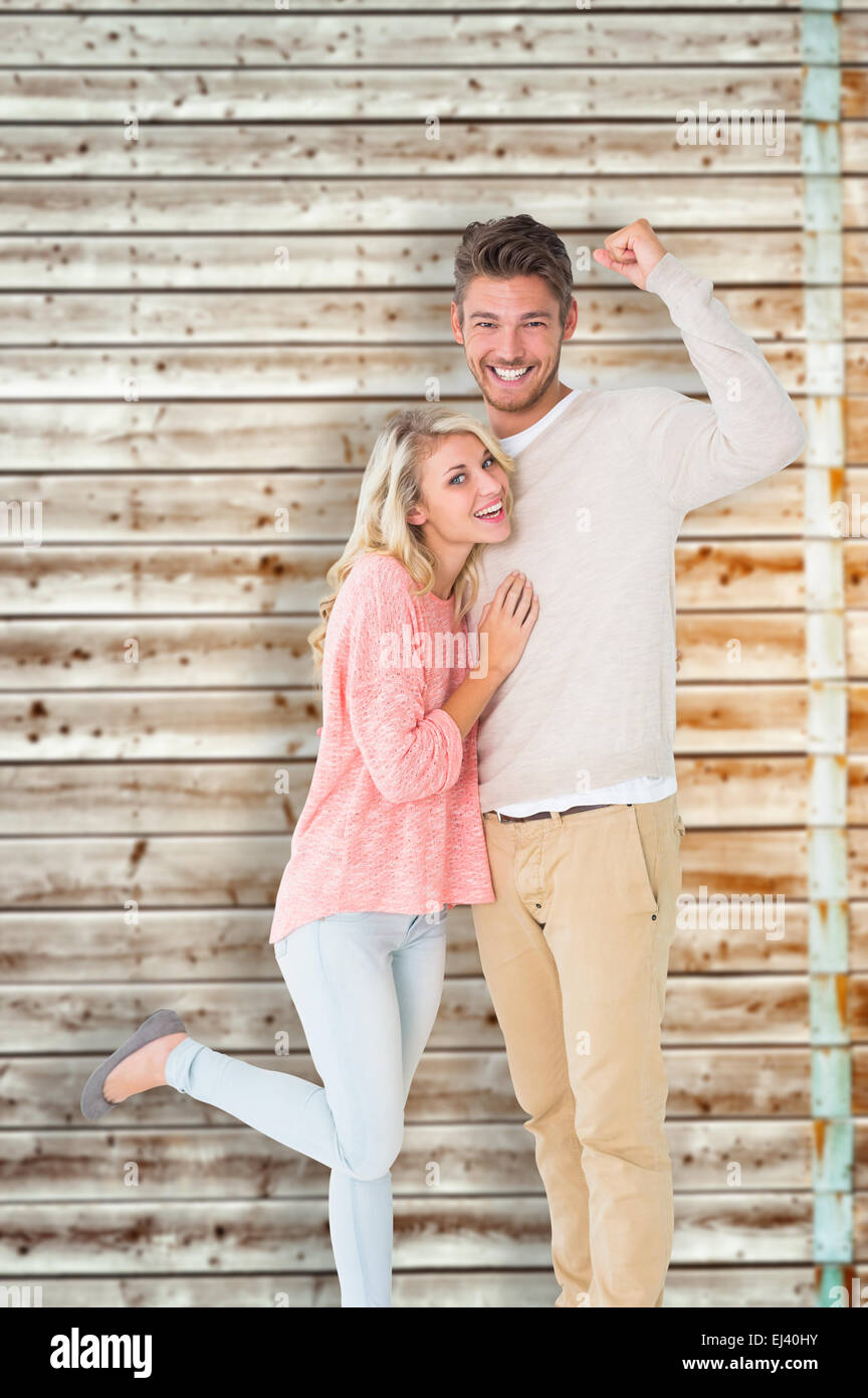 Composite image of attractive couple smiling and cheering Stock Photo ...