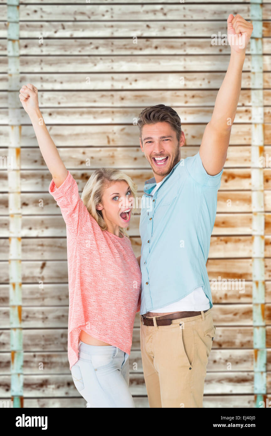 Composite image of attractive couple smiling and cheering Stock Photo ...