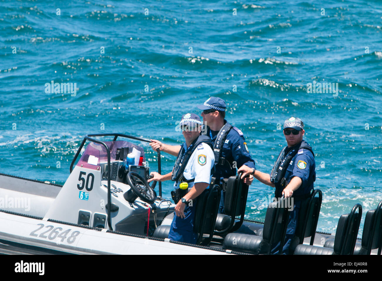 New south Wales Sydney male policemen officers on NSW Police boat on Sydney harbour, sydney,Australia Stock Photo