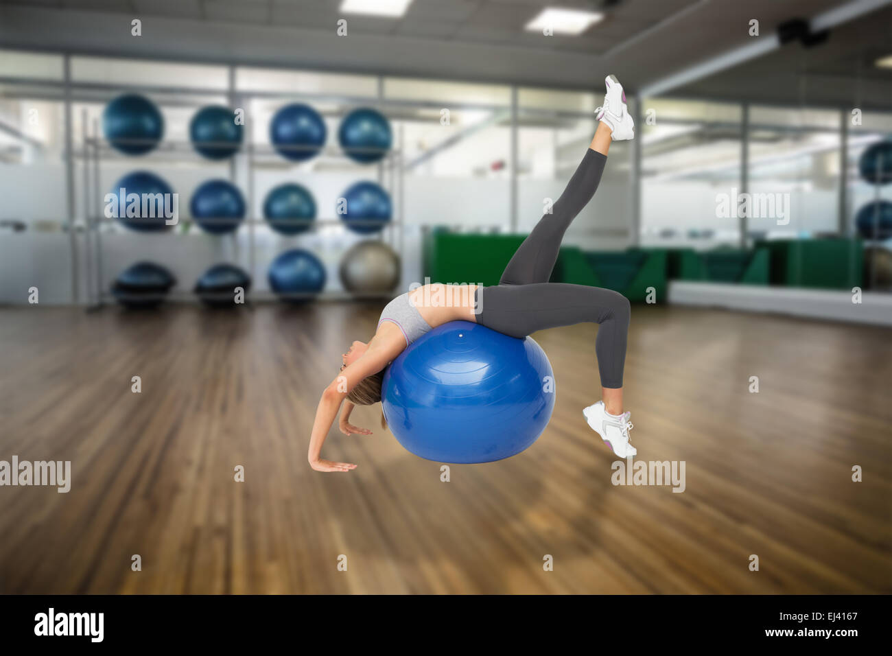 Composite image of fit young woman stretching on fitness ball Stock ...