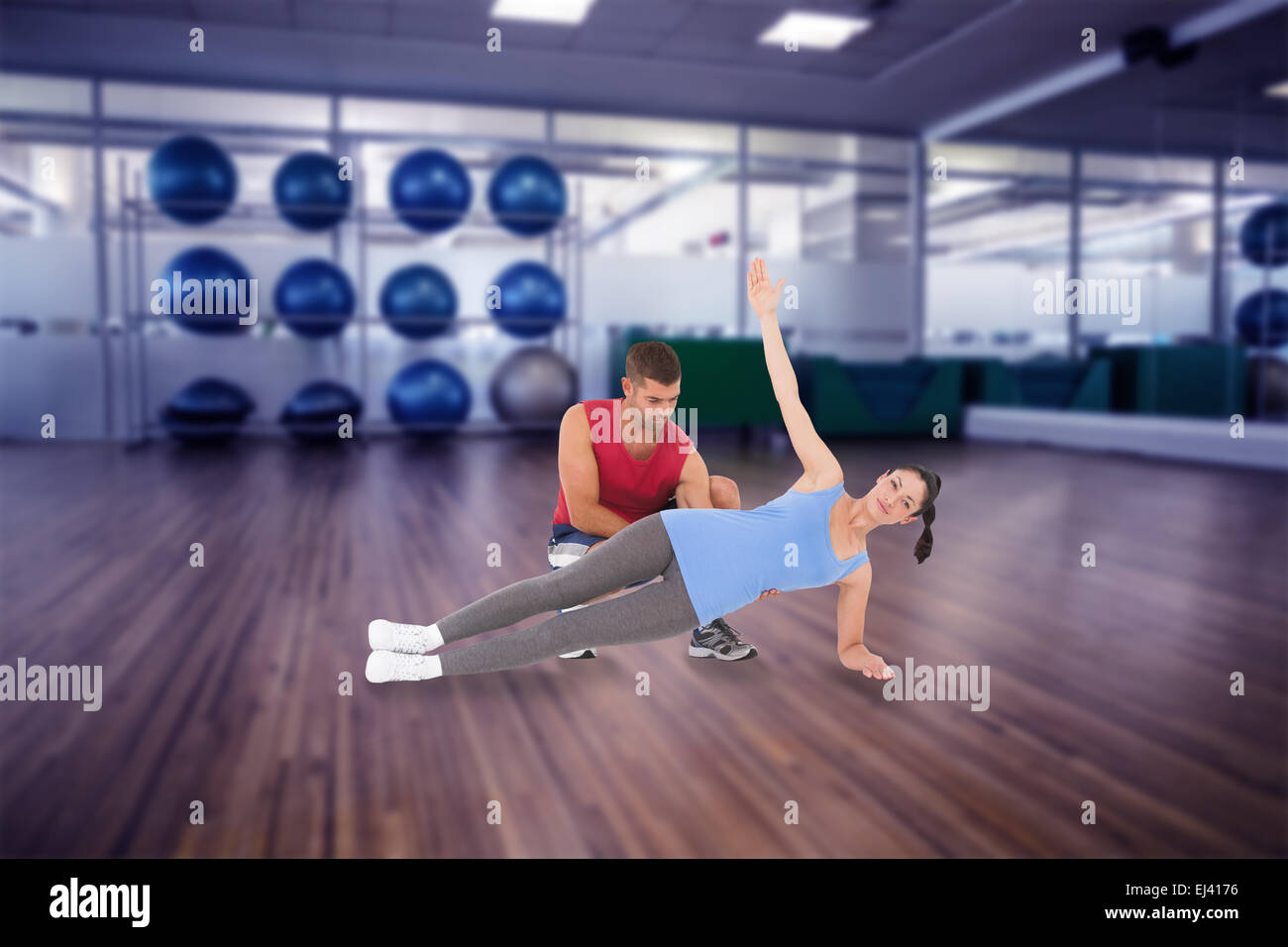 Composite image of personal trainer with client Stock Photo