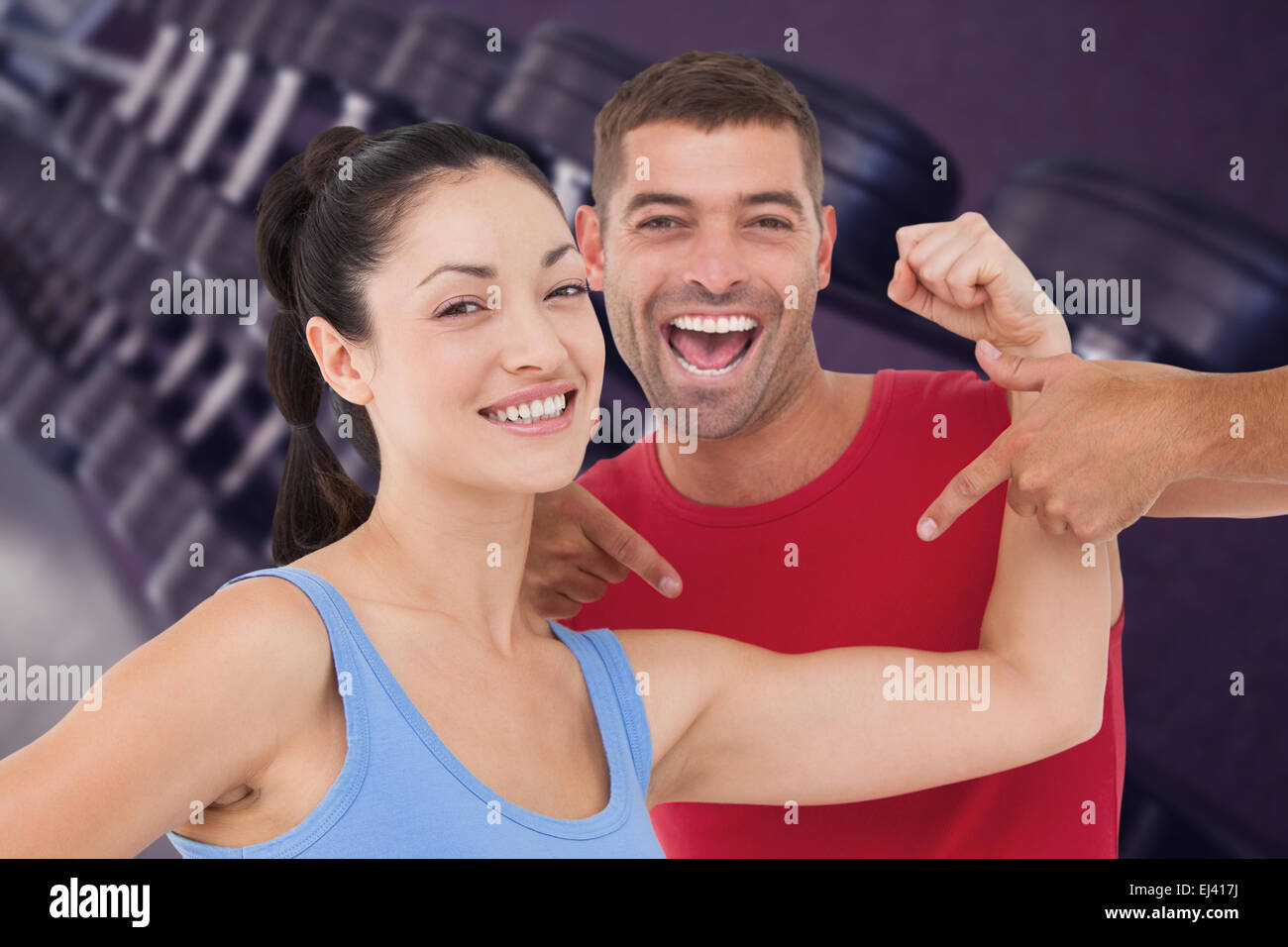 Composite image of fit woman and trainer smiling at camera Stock Photo