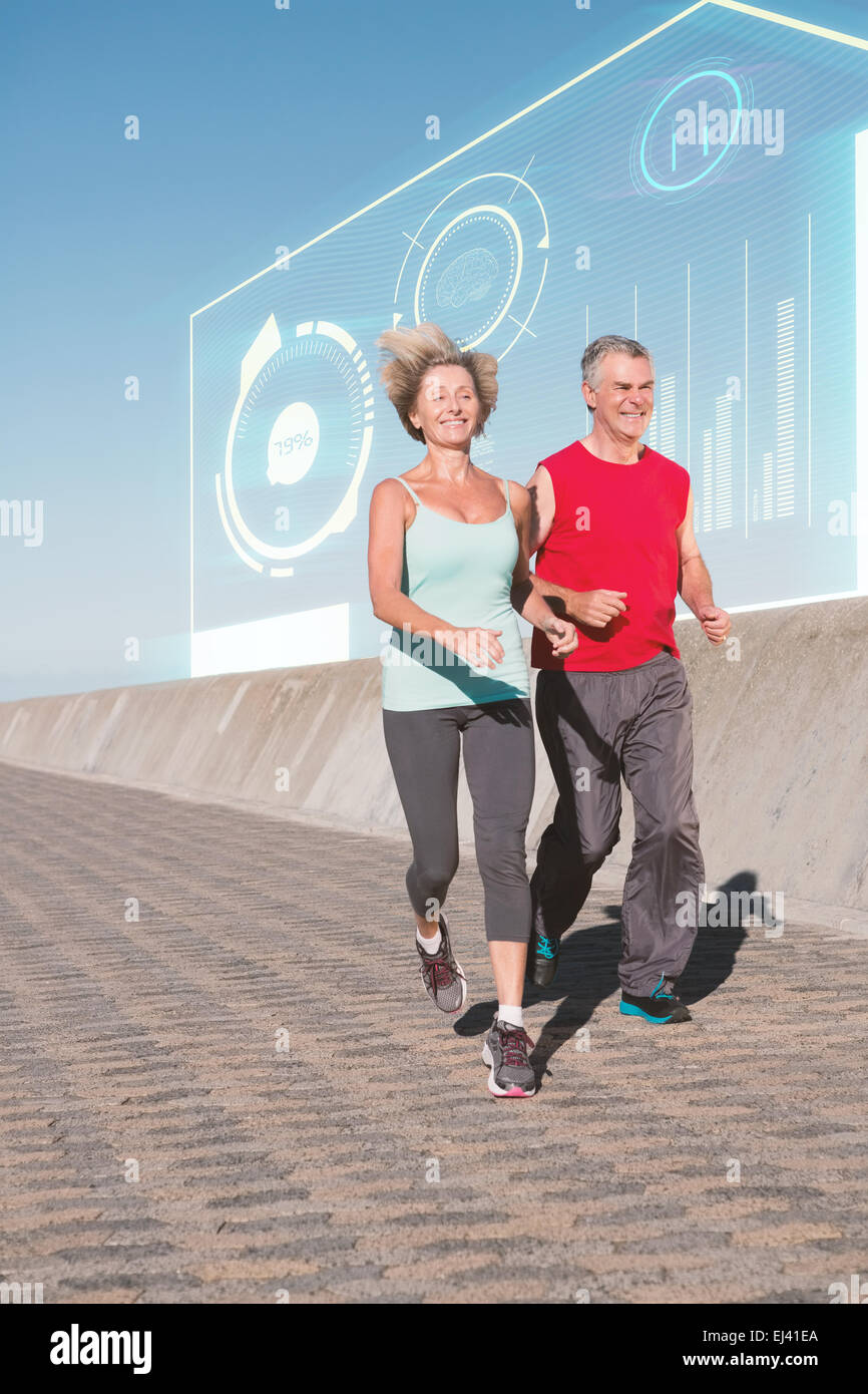 Composite image of active senior couple out for a jog Stock Photo