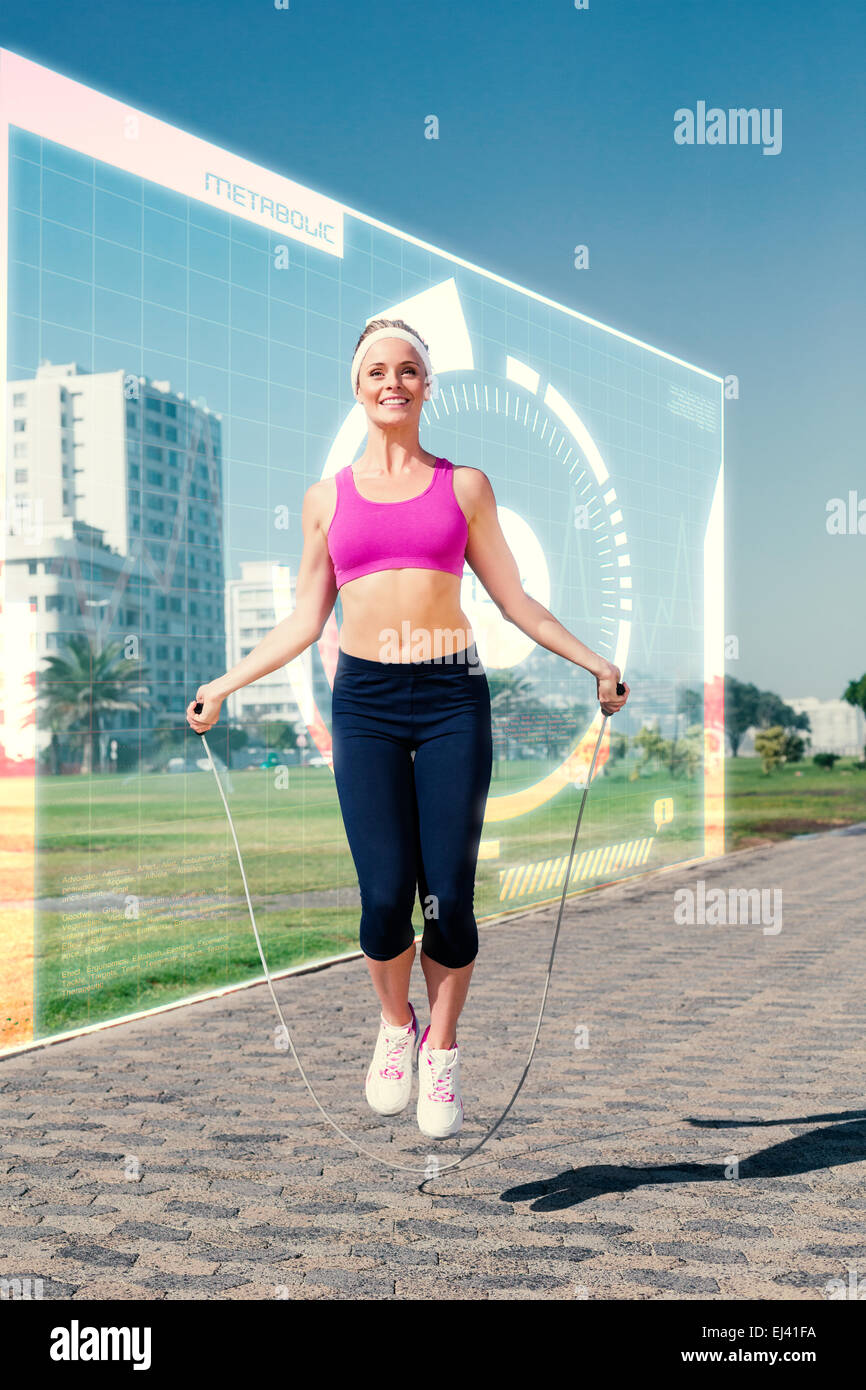 Composite image of fit blonde skipping rope on the pier Stock Photo - Alamy
