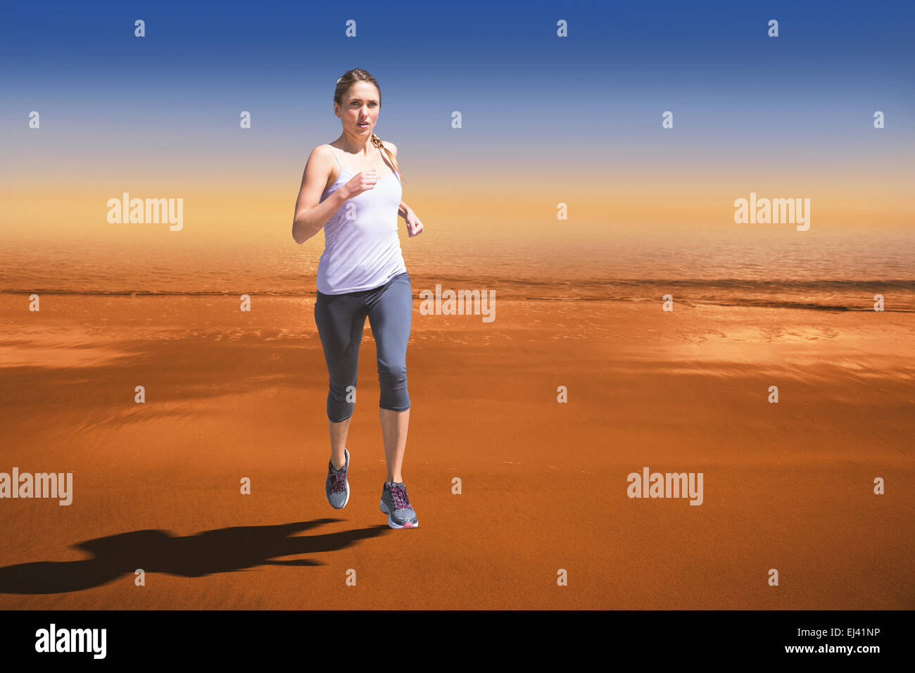 Composite image of focused fit blonde jogging Stock Photo