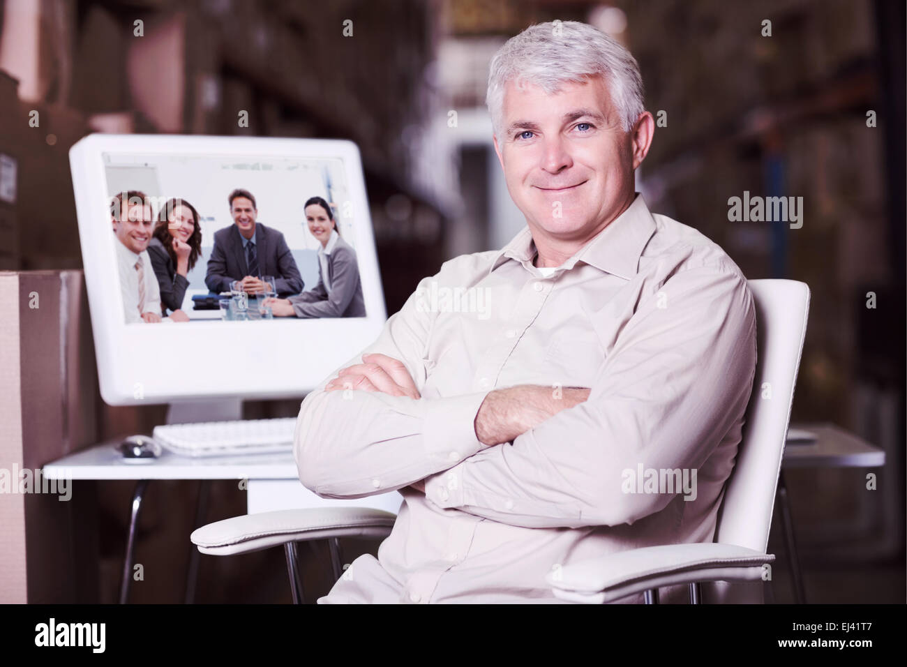 Composite image of warehouse manager using computer Stock Photo