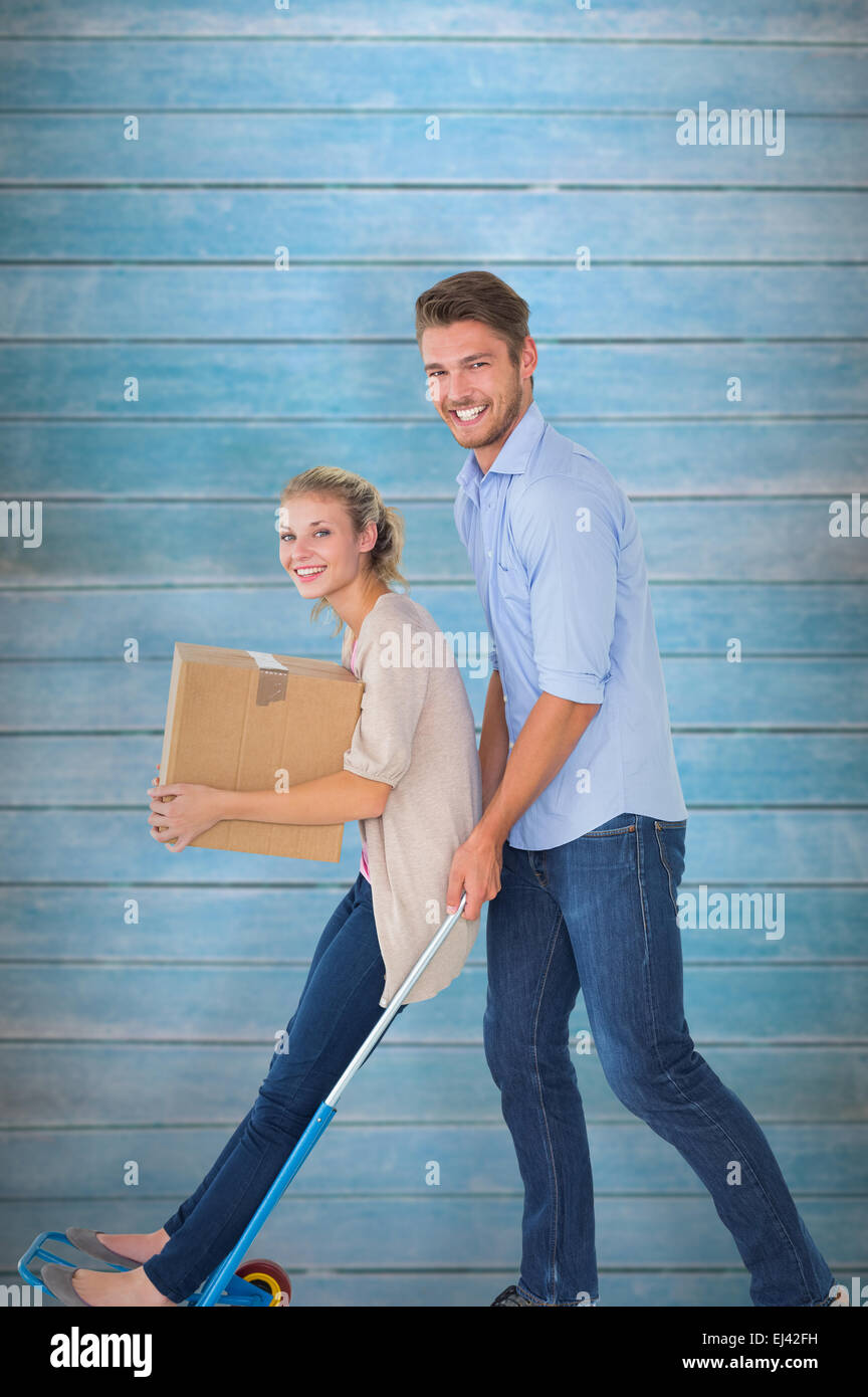 Composite image of young couple having fun on moving trolley Stock ...