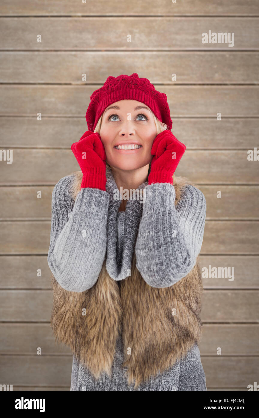 Composite image of blonde in winter clothes smiling Stock Photo