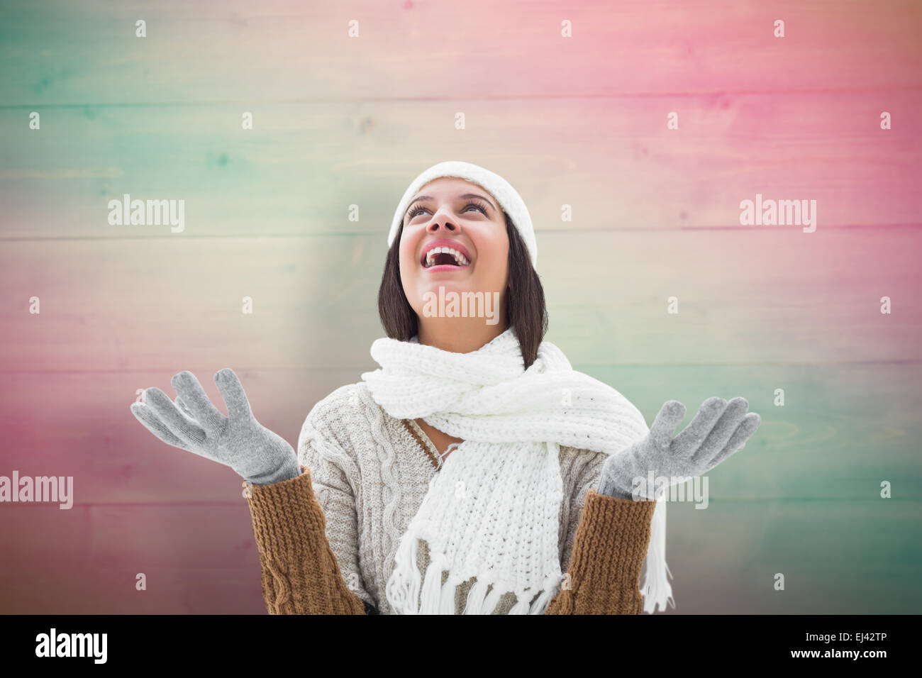 Composite image of brunette in warm clothing Stock Photo