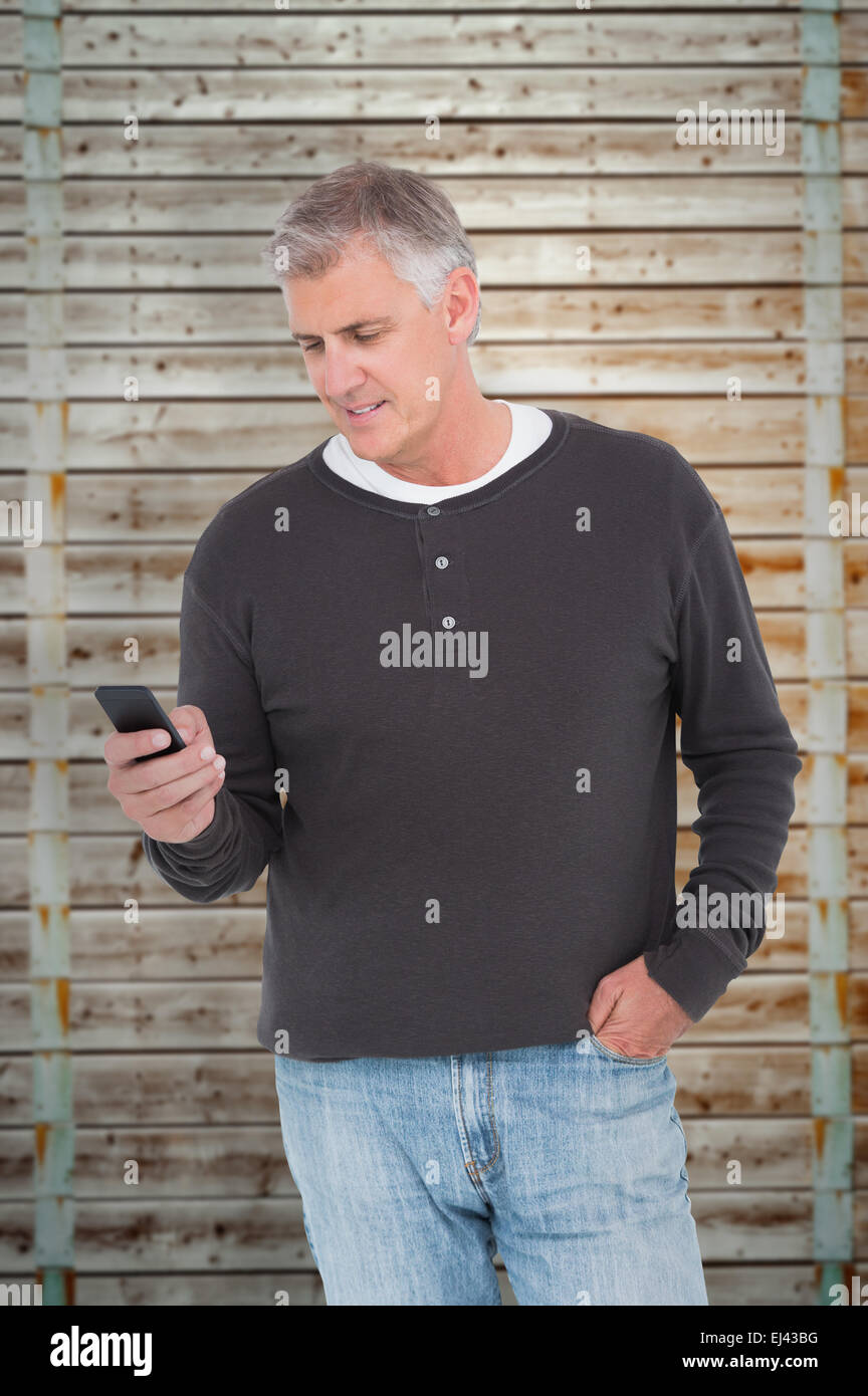 Composite image of casual man sending a text Stock Photo