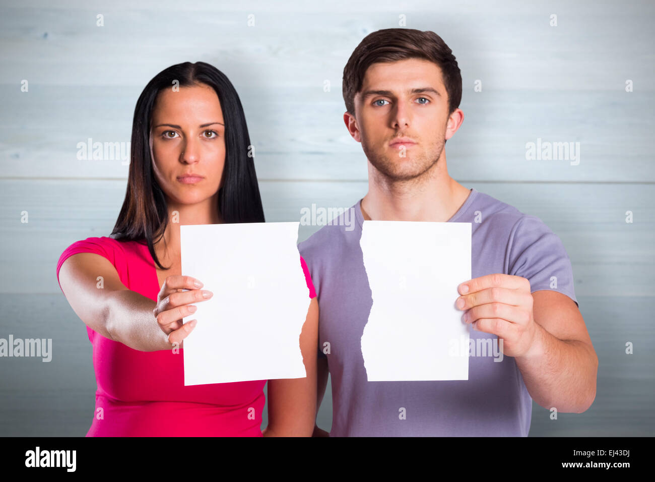 Composite image of couple showing broken piece of paper Stock Photo