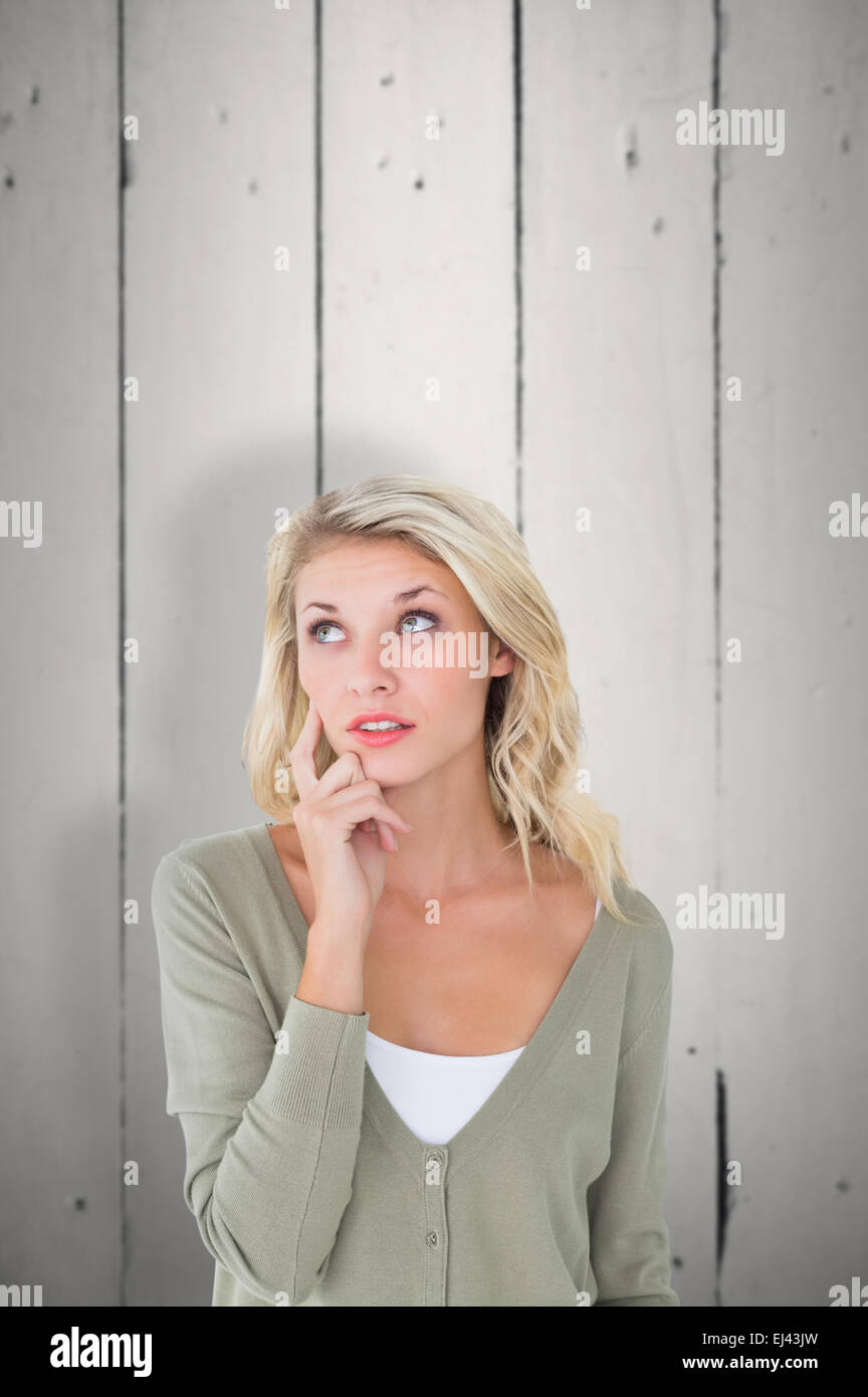 Composite image of pretty young blonde looking up Stock Photo