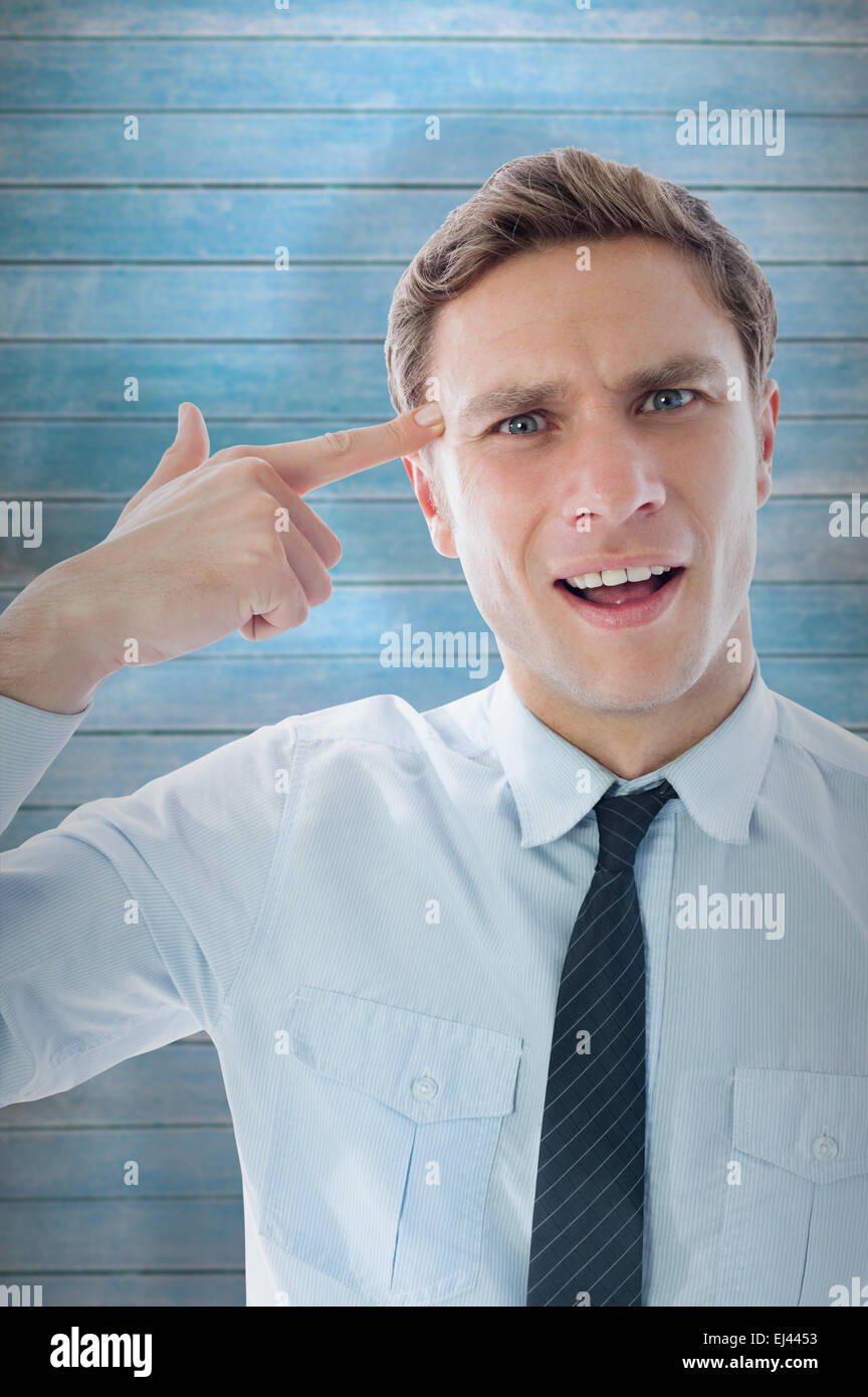 Composite image of businessman making gun gesture Stock Photo