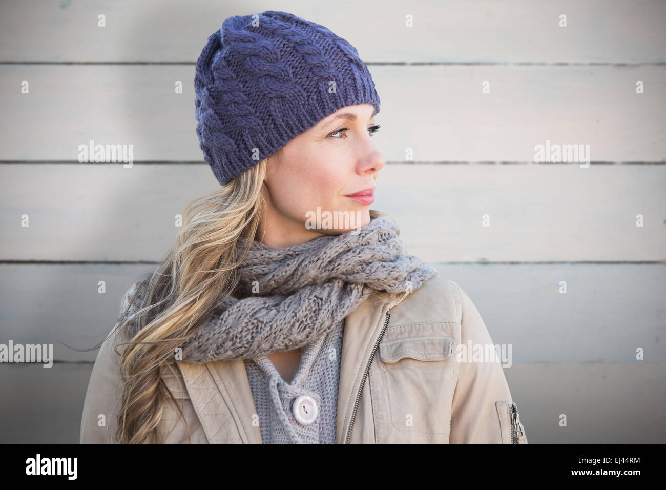 Composite image of pretty blonde in warm clothes Stock Photo