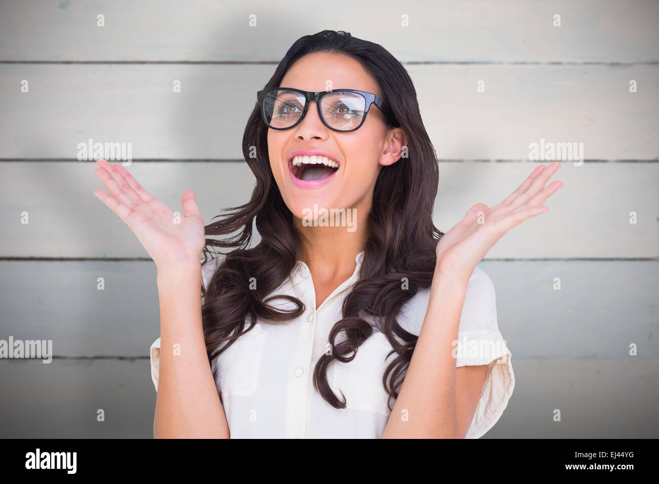 Composite image of pretty brunette in hipster glasses Stock Photo