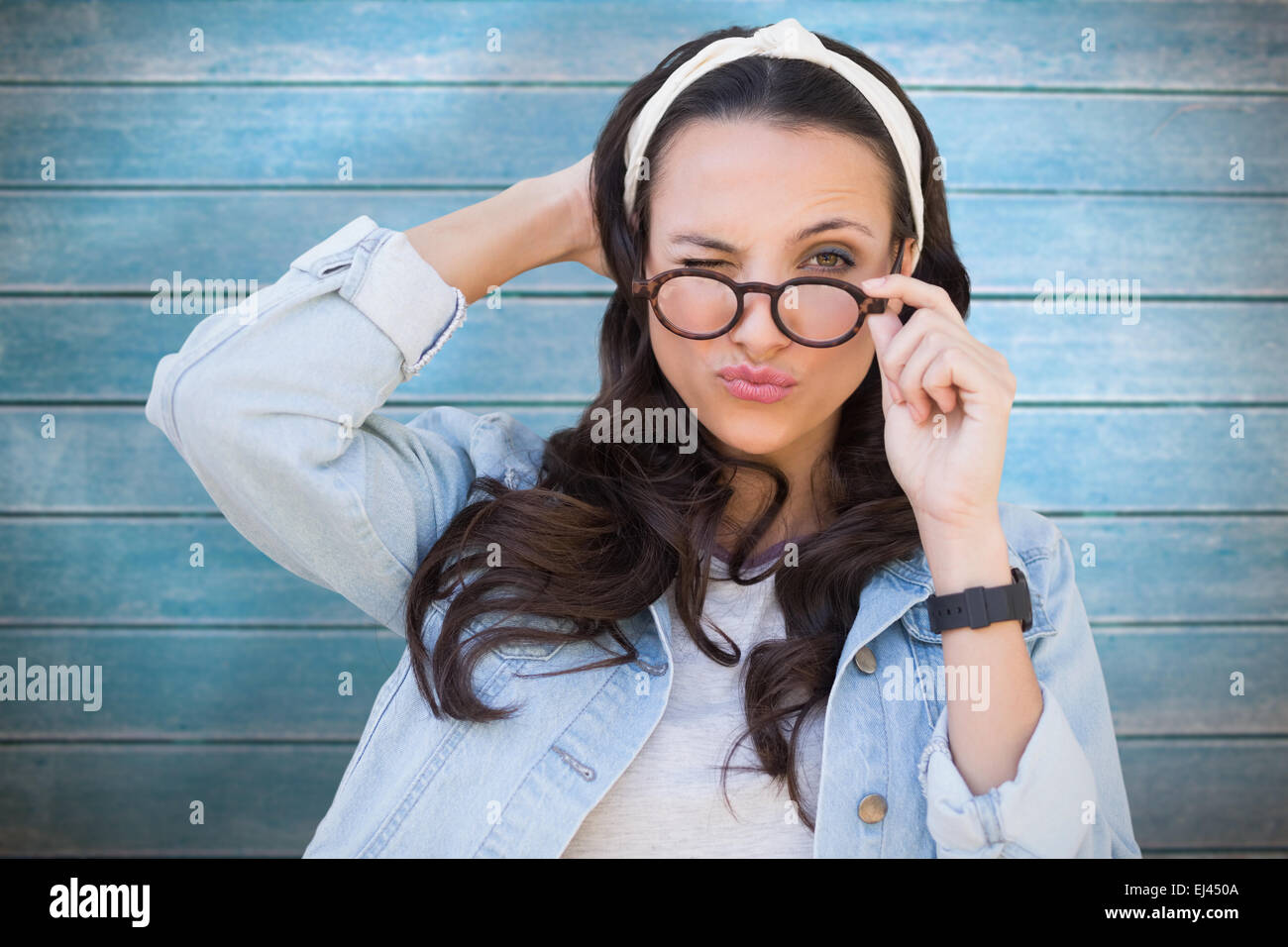 Composite image of brunette winking Stock Photo