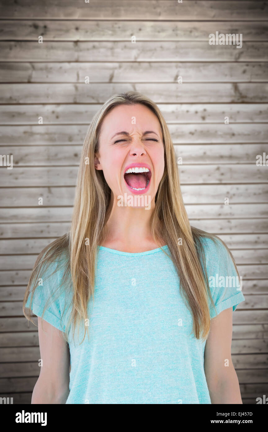 Composite image of furious blonde standing and screaming Stock Photo