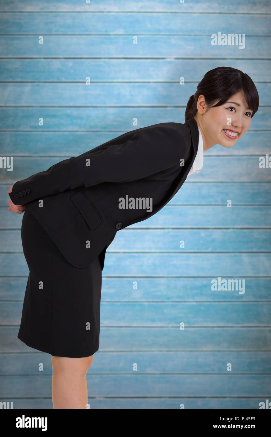 Composite image of smiling businesswoman bending Stock Photo