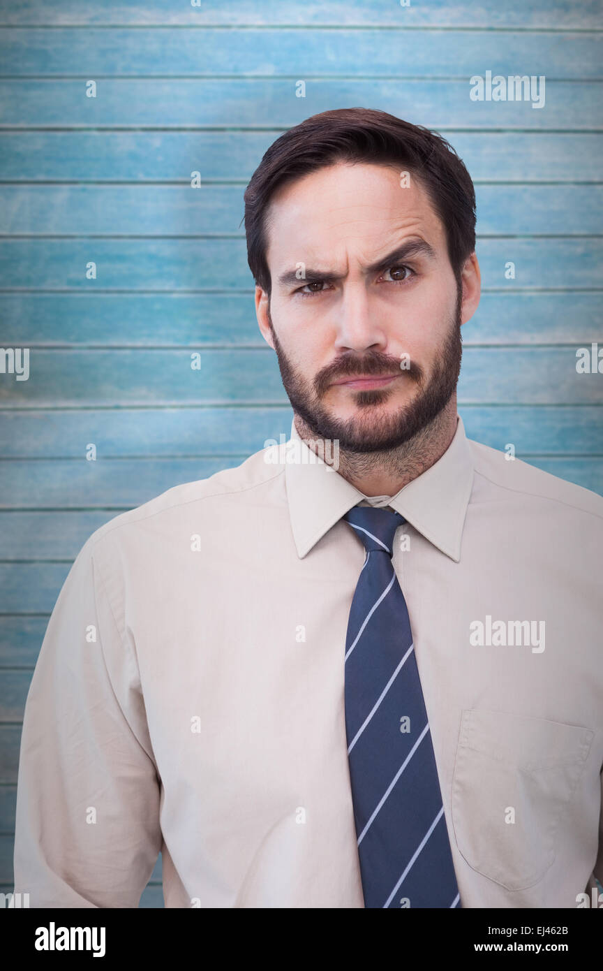 Composite image of portrait of a doubtful young businessman Stock Photo