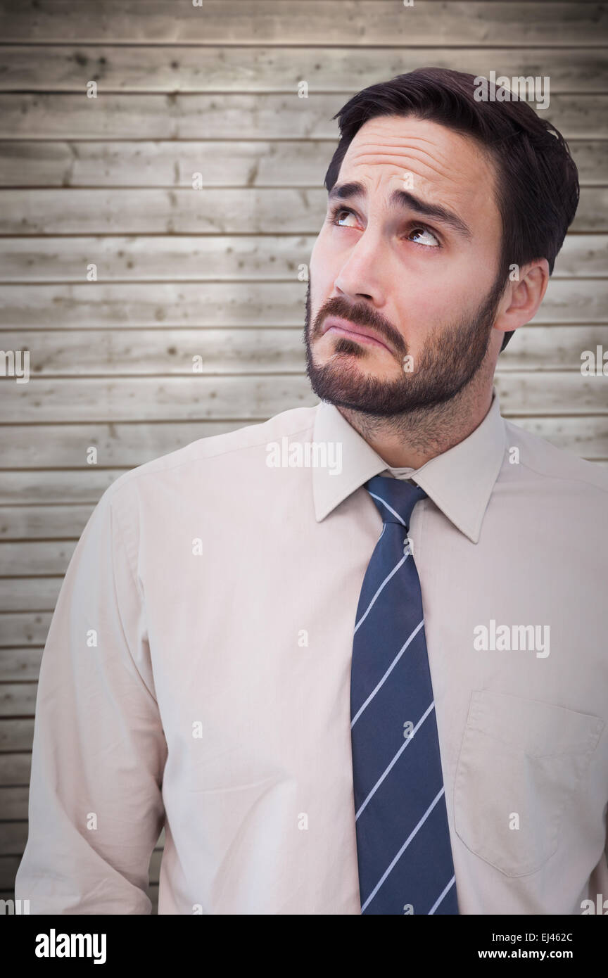 Composite image of portrait of a nervous businessman looking up Stock Photo
