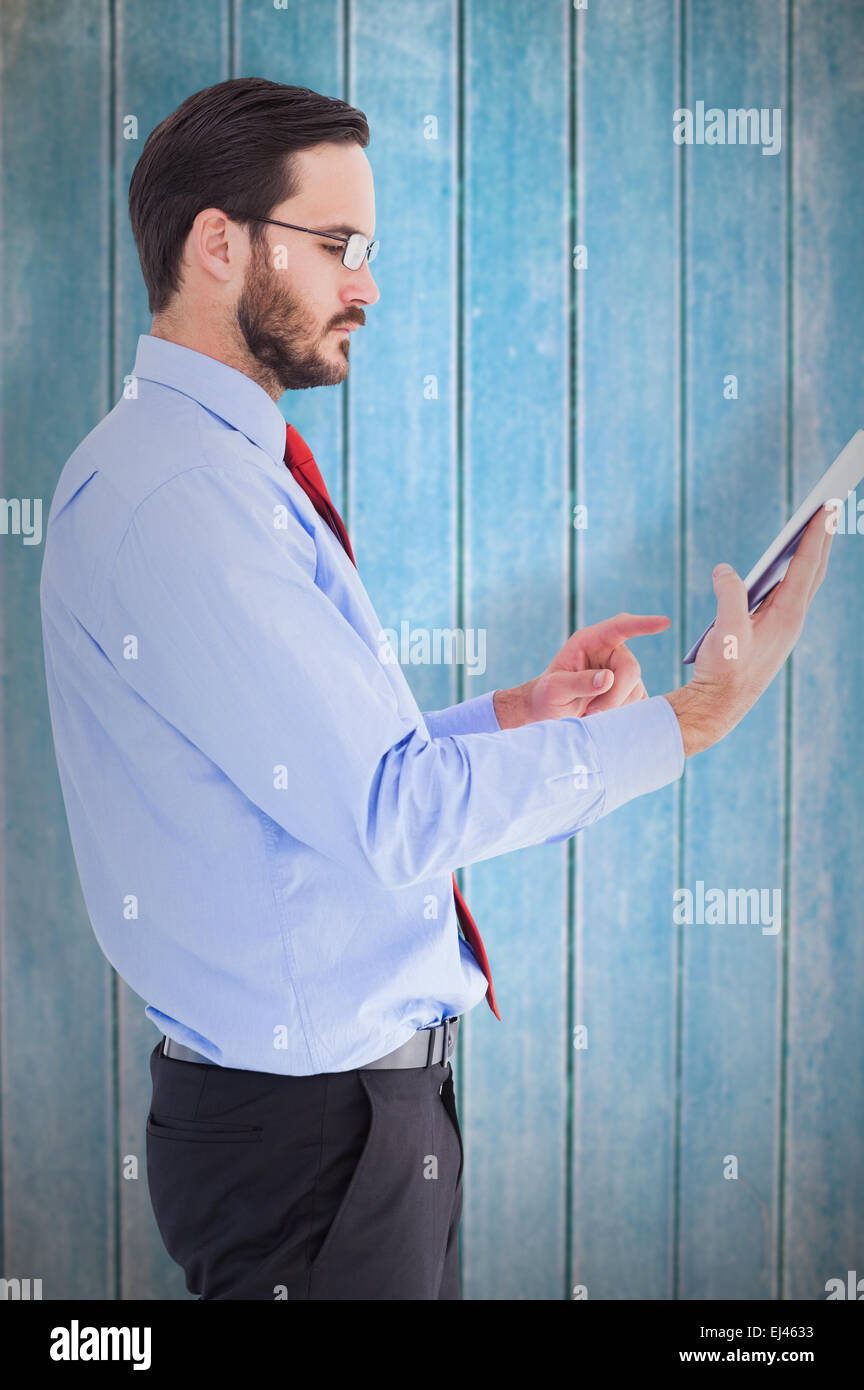 Composite image of businessman scrolling on his digital tablet Stock Photo