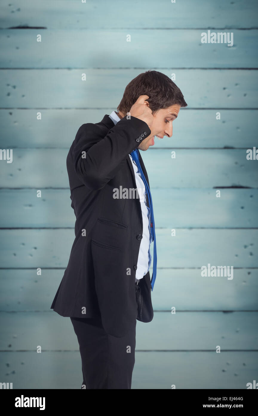 Composite image of thinking businessman scratching head Stock Photo