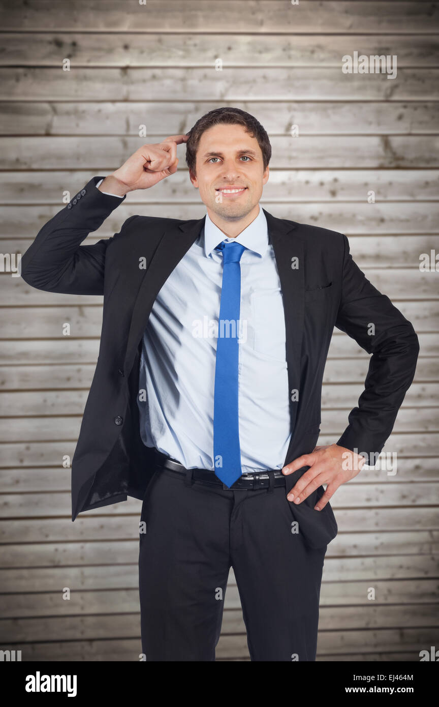 Composite image of thinking businessman scratching head Stock Photo