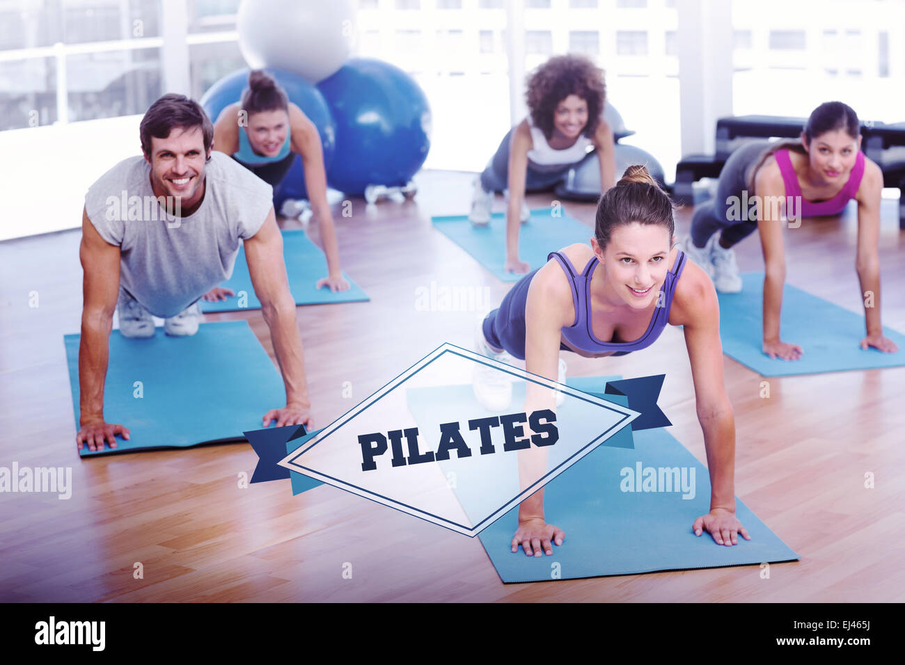 The word pilates and people doing push ups in fitness studio Stock Photo