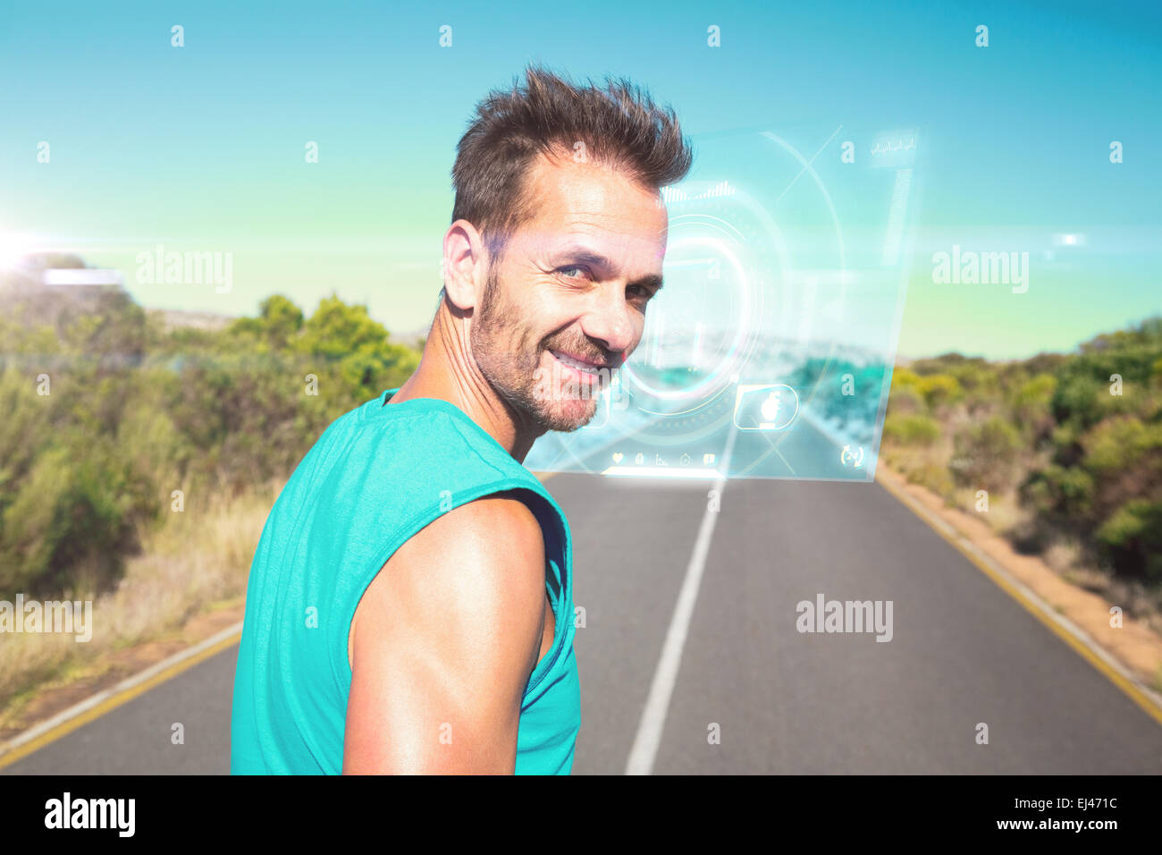 Composite image of fit man jogging on the open road smiling at camera Stock Photo