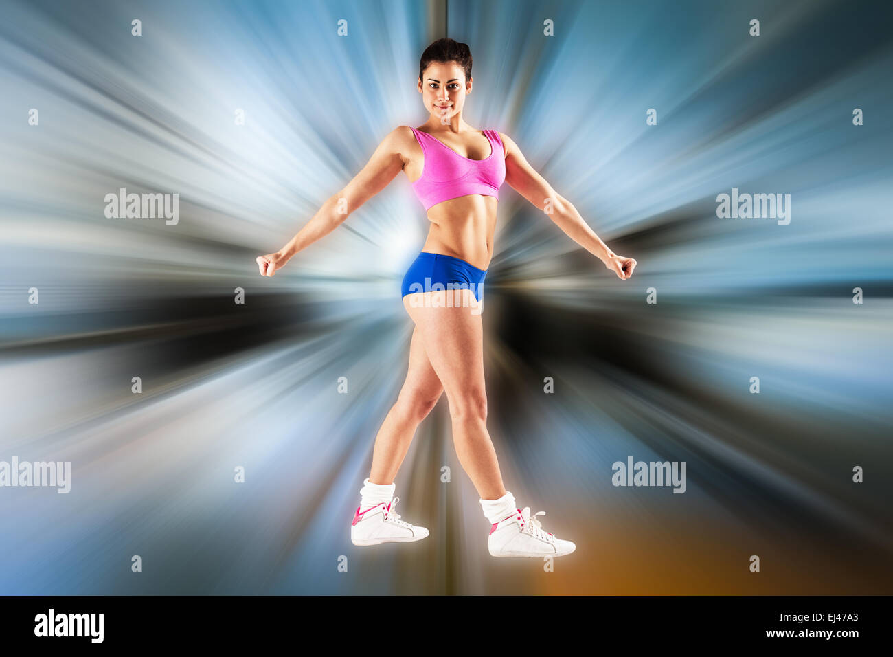 Composite image of fit brunette posing and looking at camera Stock Photo