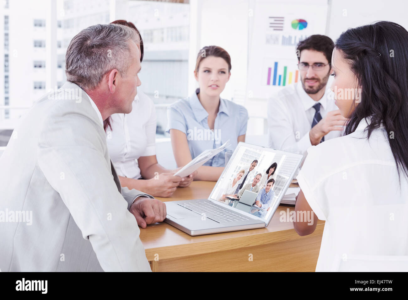 Business people gathered around laptop hi-res stock photography and ...