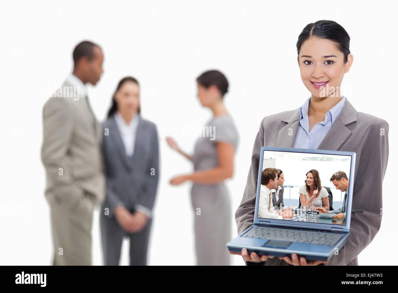 Composite image of glad businesswoman talking to her team Stock Photo