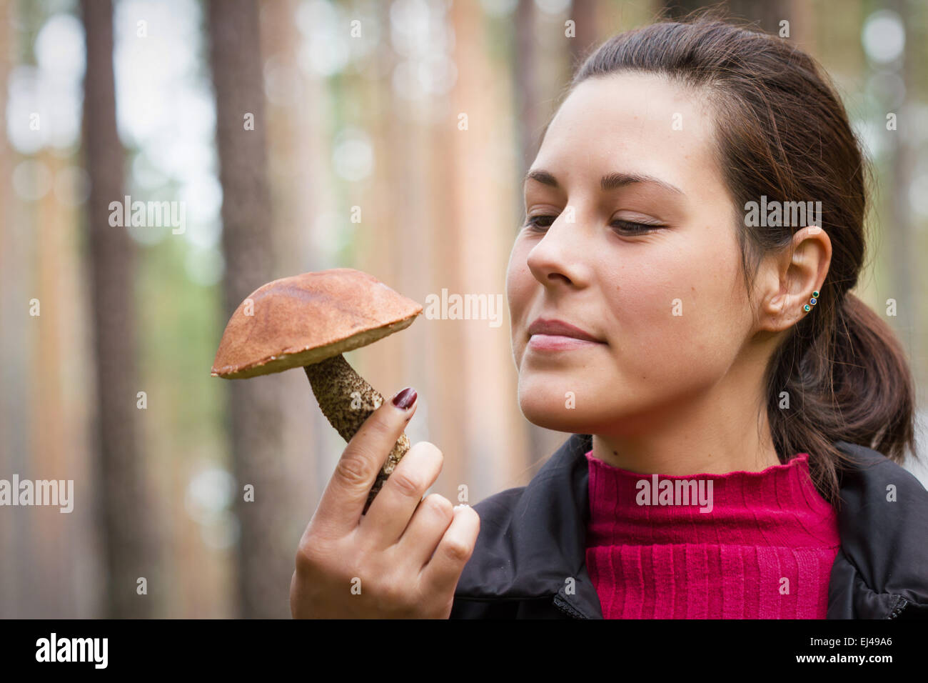 Woman with an edible mushroom in the forest Stock Photo