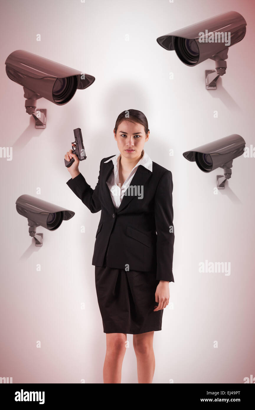 Composite image of businesswoman holding a gun Stock Photo