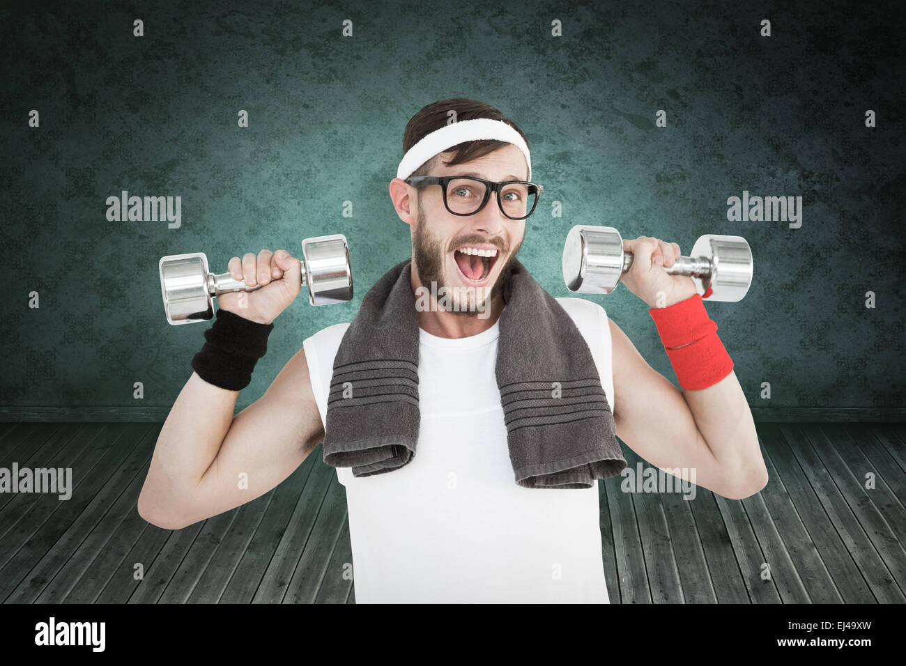 Composite image of geeky hipster lifting dumbbells in sportswear Stock Photo