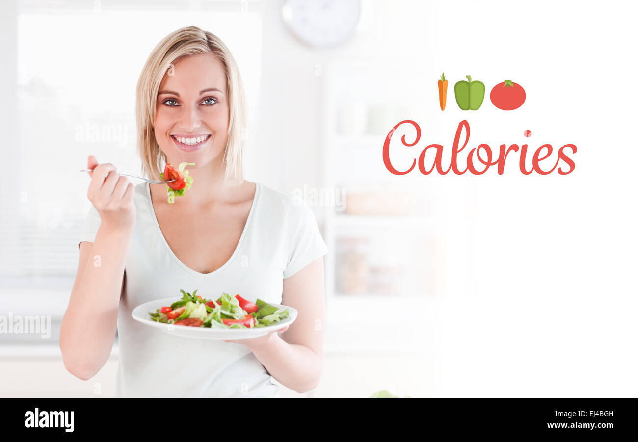 Calories against close up of a gorgeous woman eating salad Stock Photo
