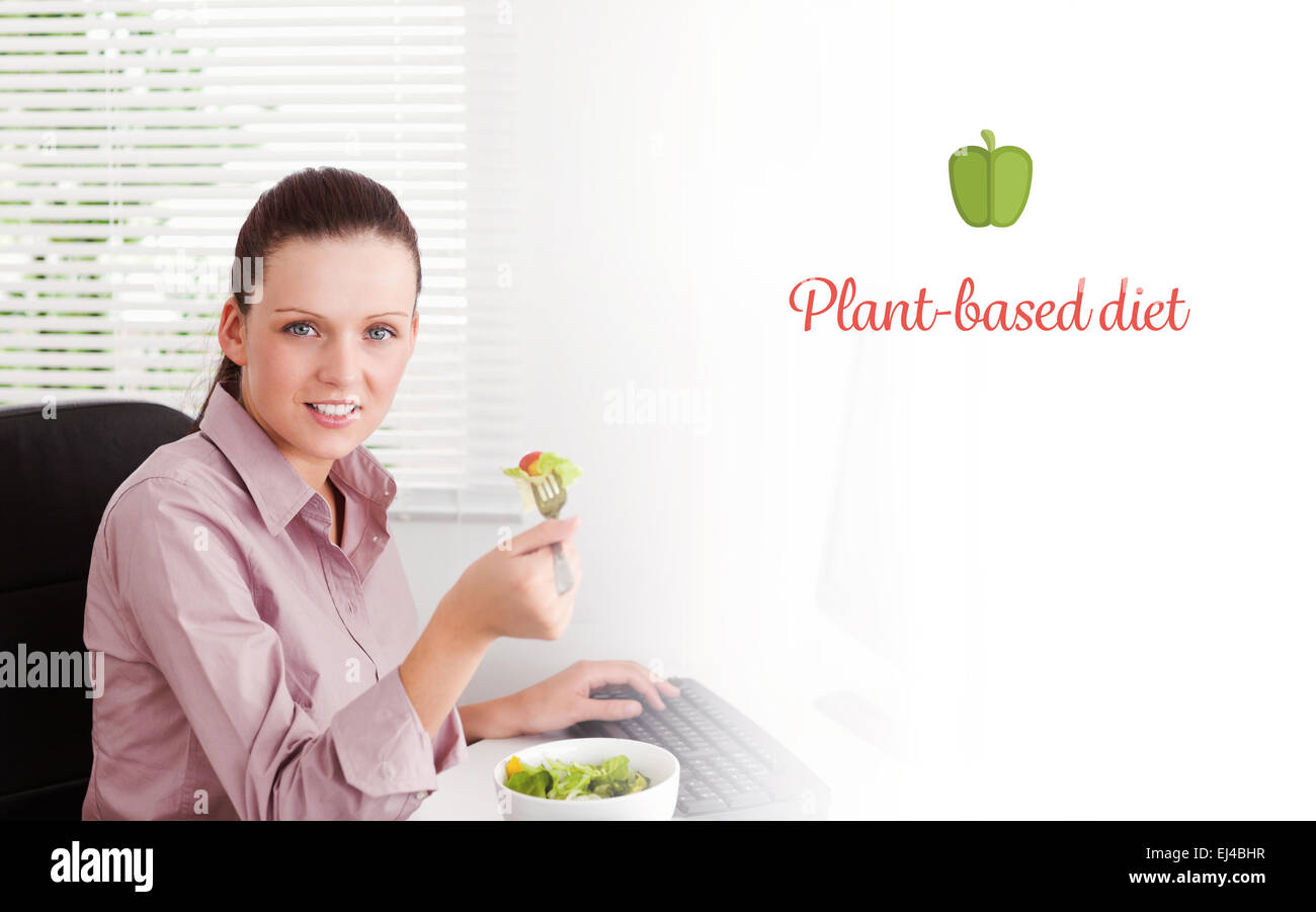 Plant-based diet against businesswoman eats salad Stock Photo