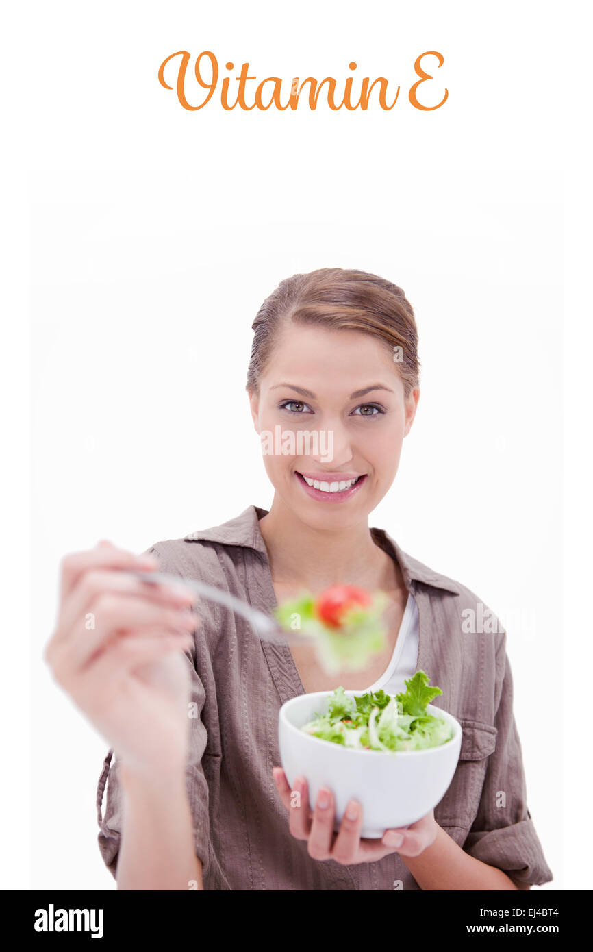 Vitamin e against woman with bowl of salad offering some Stock Photo