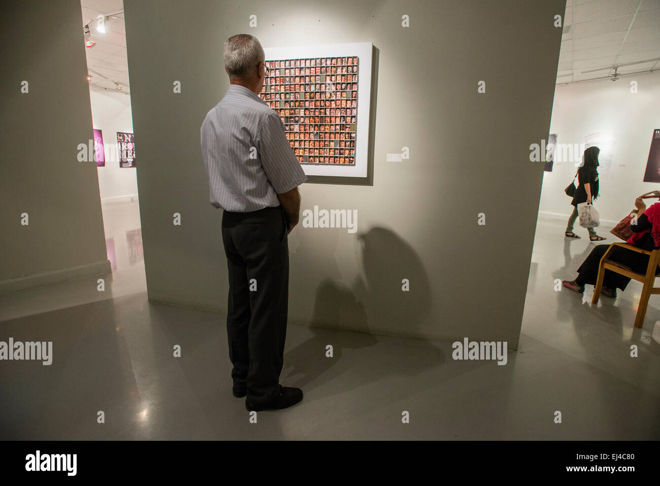 Visitor watches contemporary visual art exhibition during 2nd Grand Festival of Art for Peace in Tehran, Iran Stock Photo