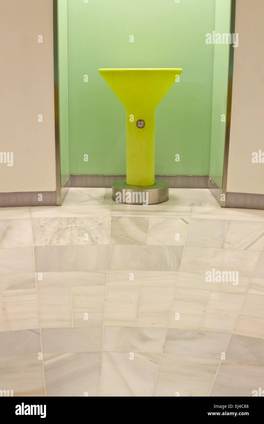 Green plastic fountain for drinking beside the toilet area of a mall Stock Photo
