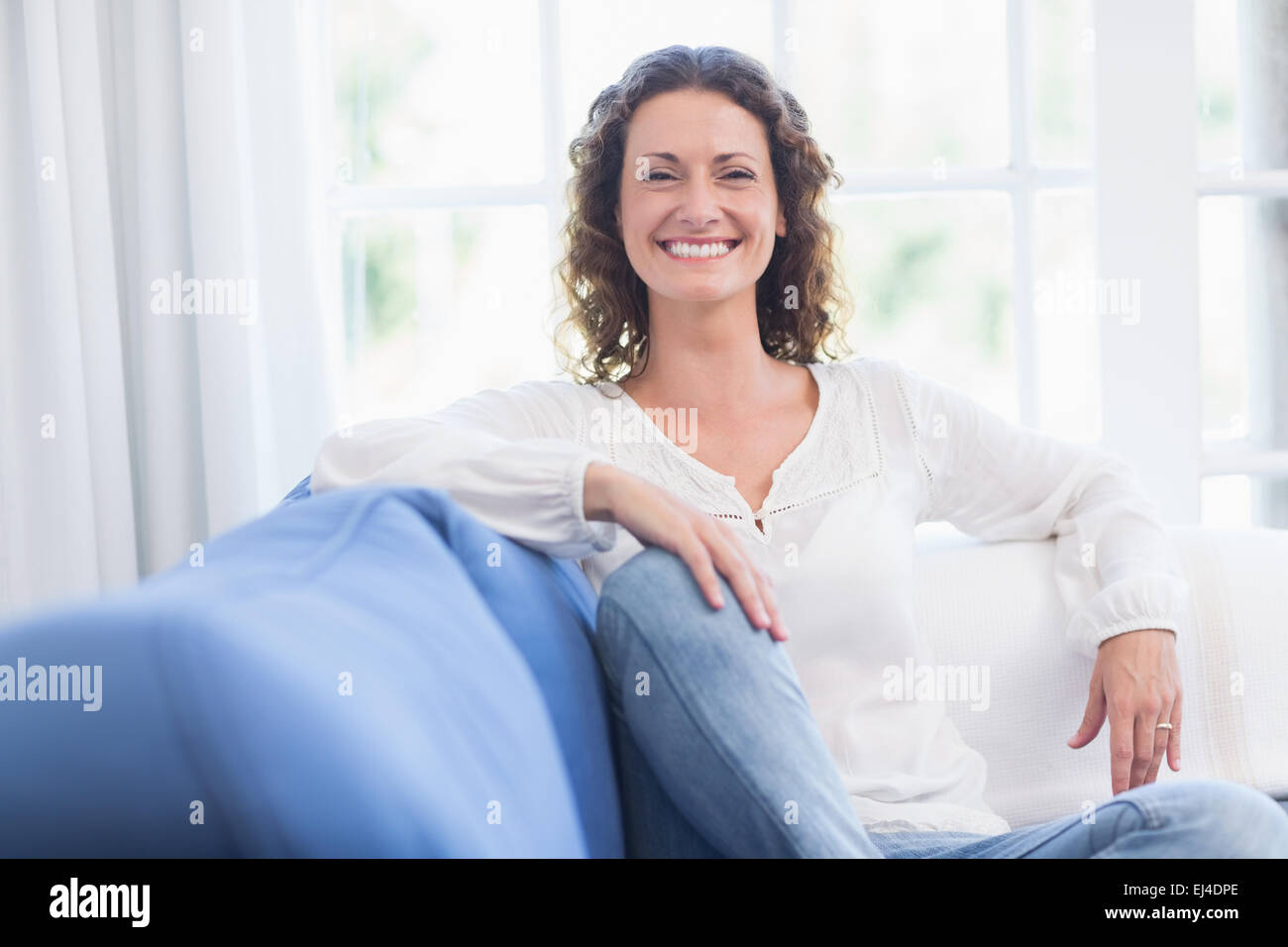 Woman relaxing on couch curly hi-res stock photography and images - Alamy