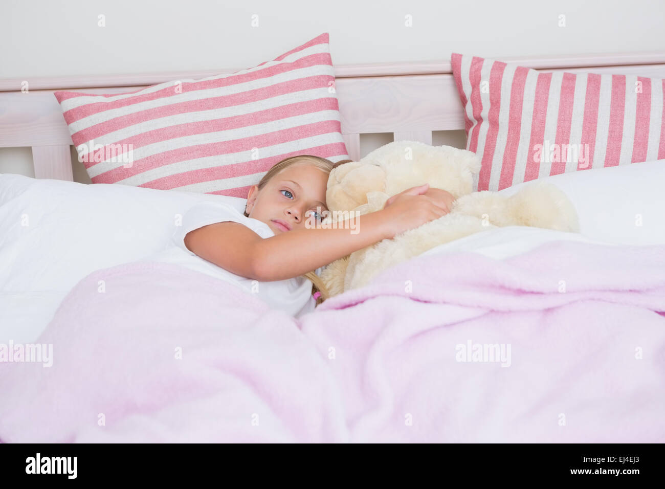 Cute little girl lying in bed Stock Photo - Alamy
