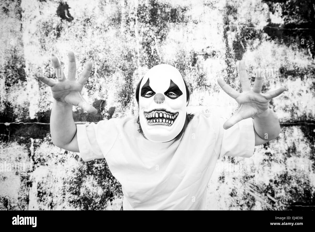 Crazy clown mask halloween costume and fear Stock Photo