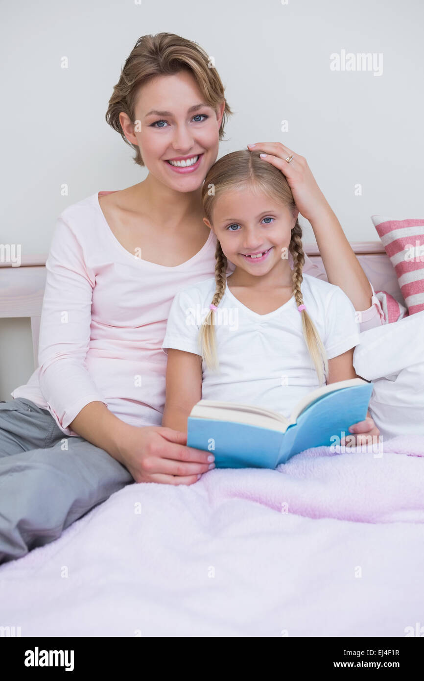Mother with her daughter at bedtime Stock Photo