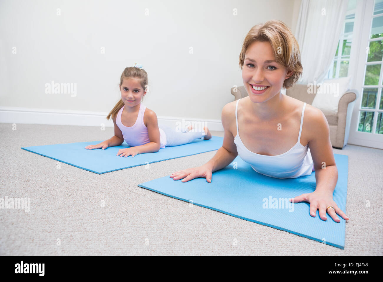 Mother and daughter doing yoga Stock Photo Alamy