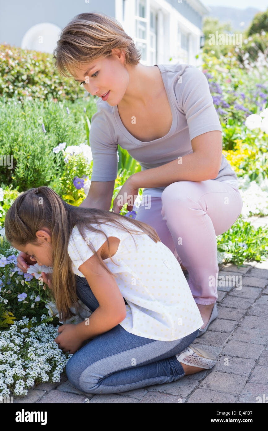 Mother and daughter tending to flowers Stock Photo