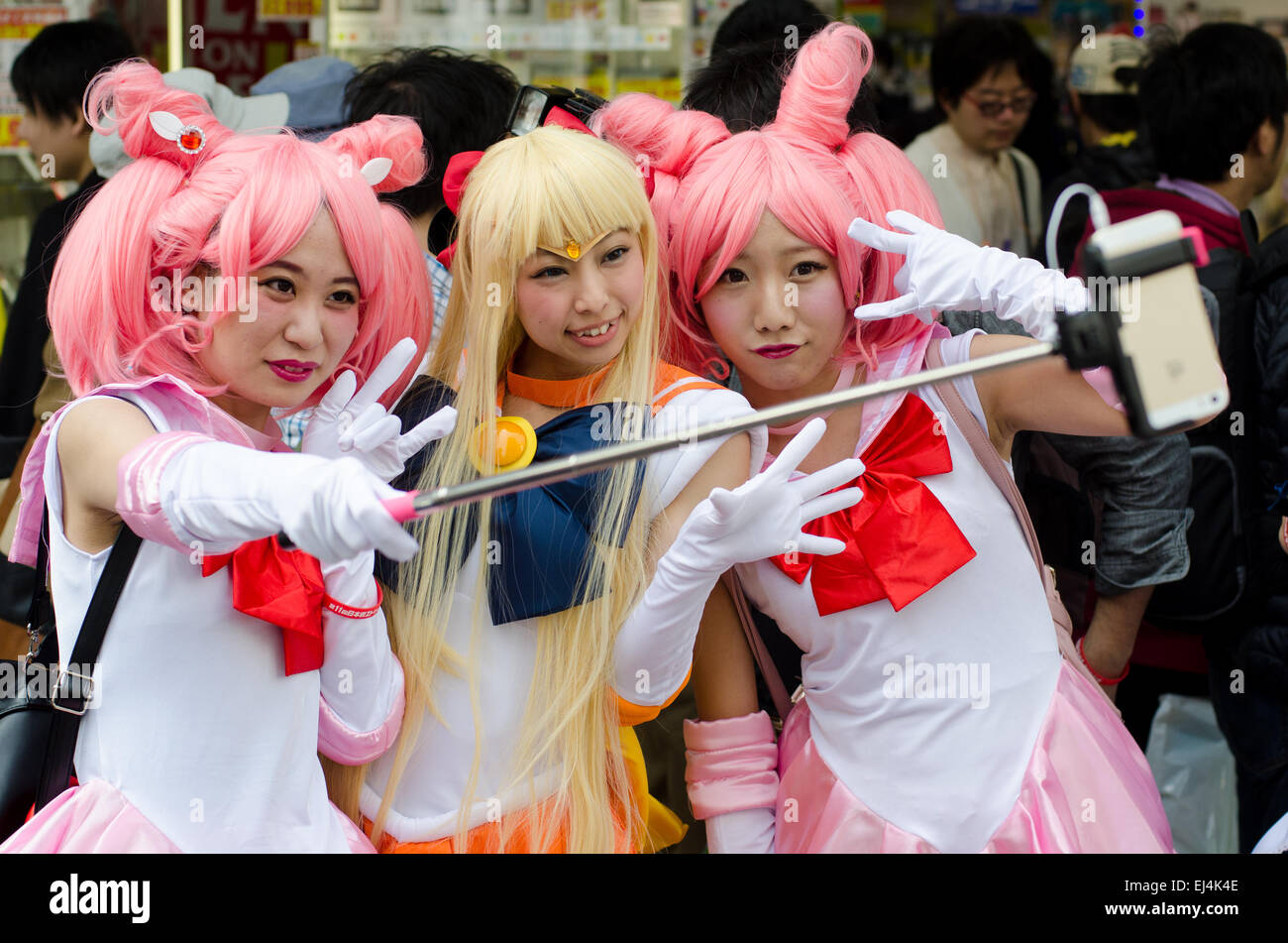 Cosplay models using a selfie stick at the annual Nipponbashi Street Festival in Osaka, Japan, in March 2015. Stock Photo