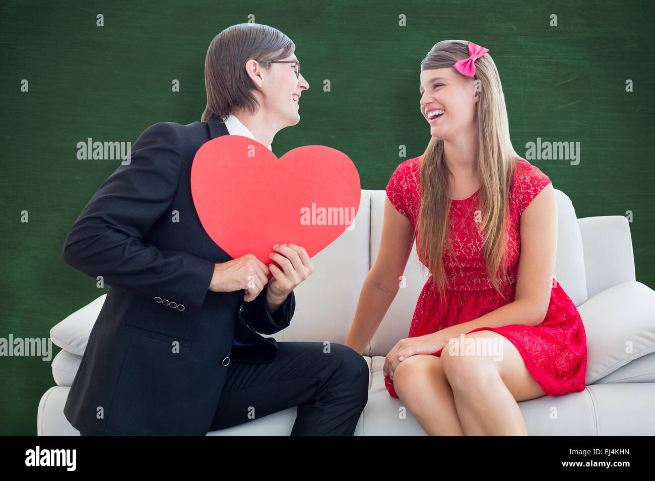 Composite image of cute geeky couple with red heart shape Stock Photo ...