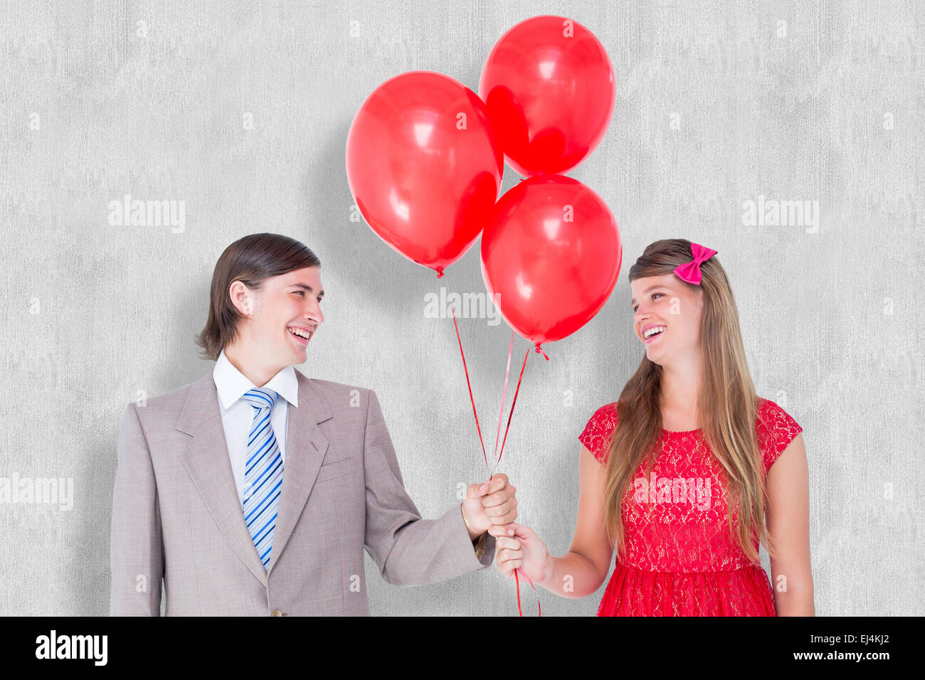 Composite image of smiling geeky couple holding red balloons Stock ...