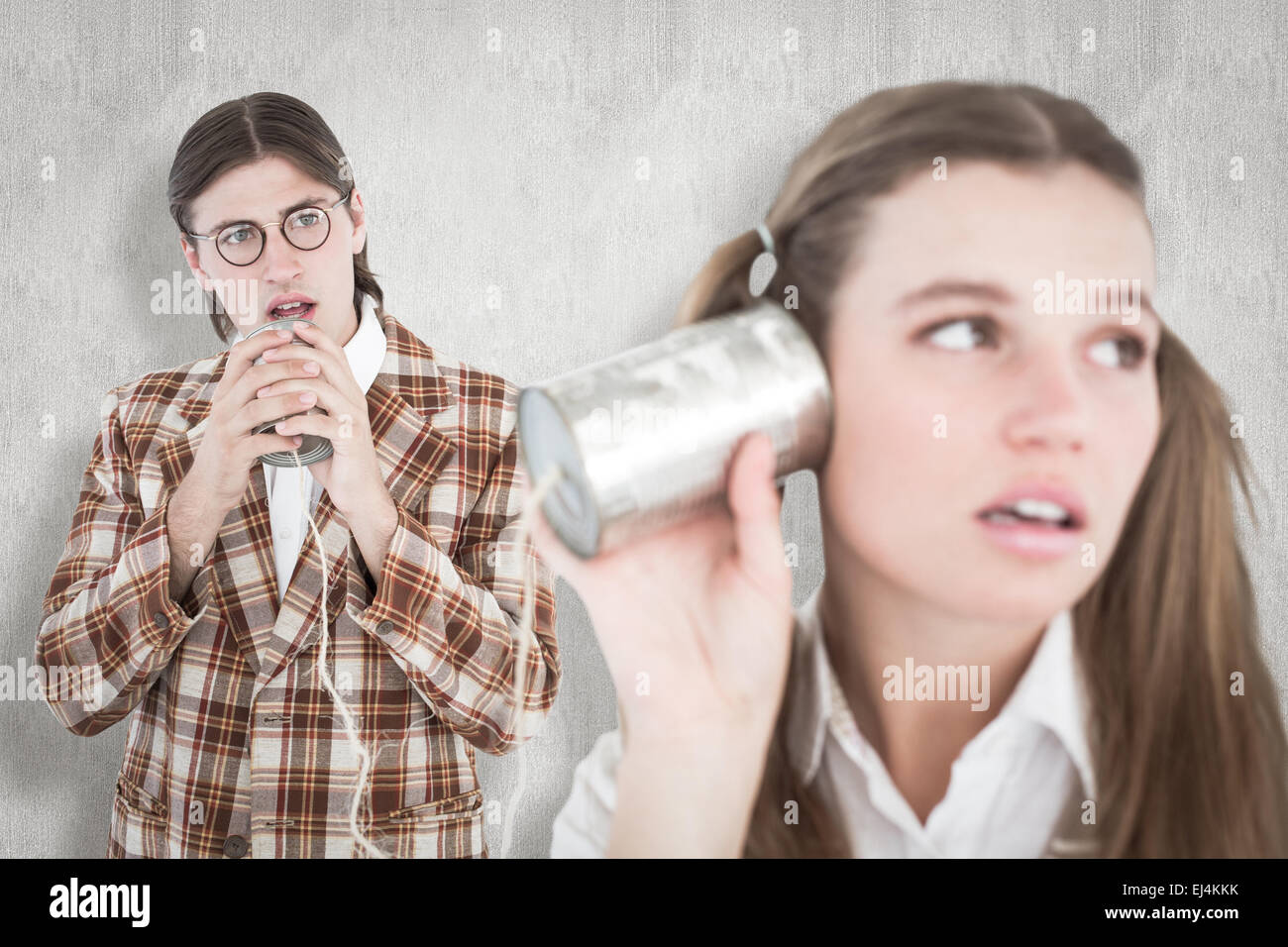 Composite image of geeky hipsters using string phone Stock Photo Alamy
